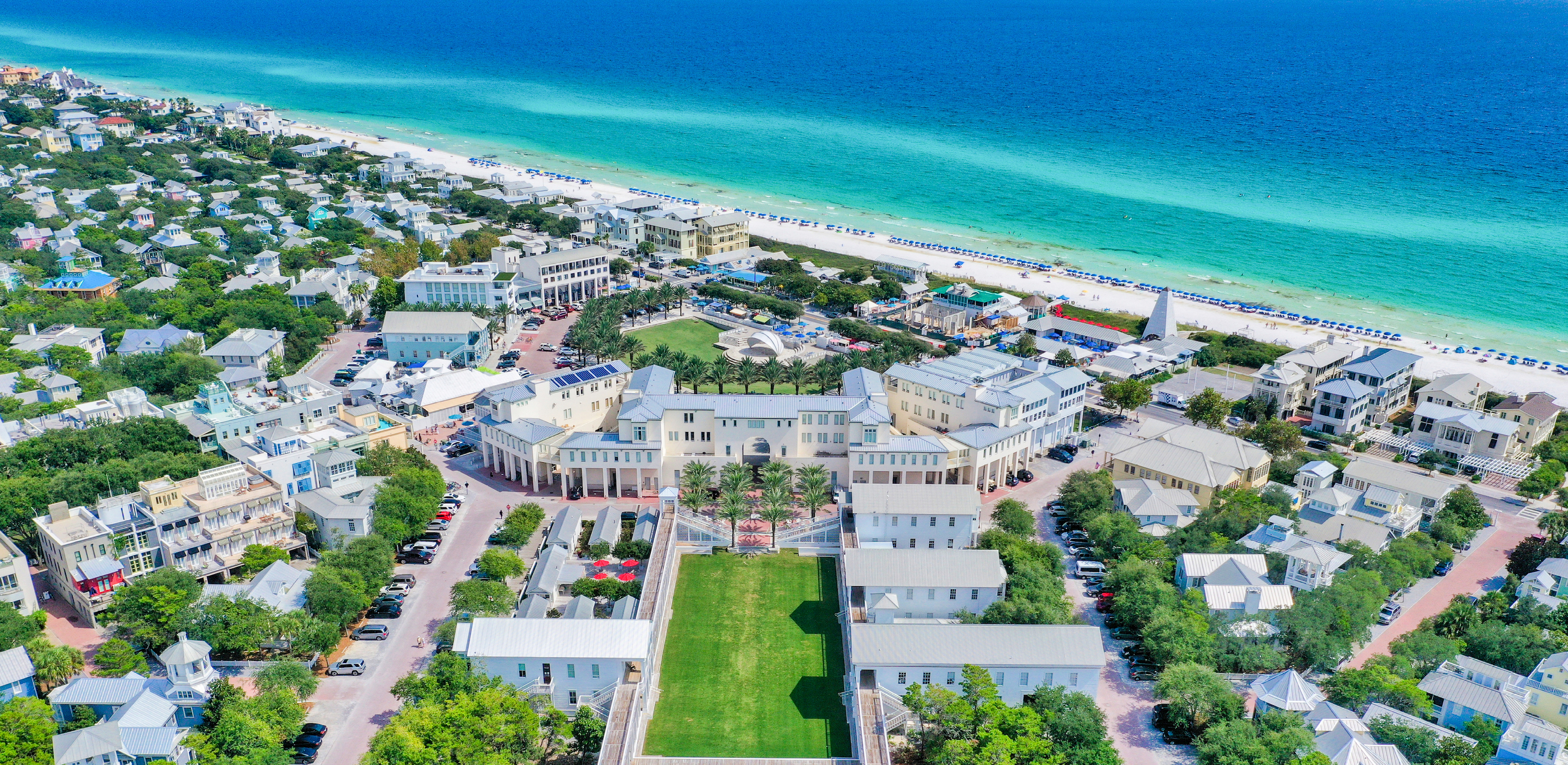 An aerial view of the Seaside community including the town center and brilliant blue gulf waters in the background